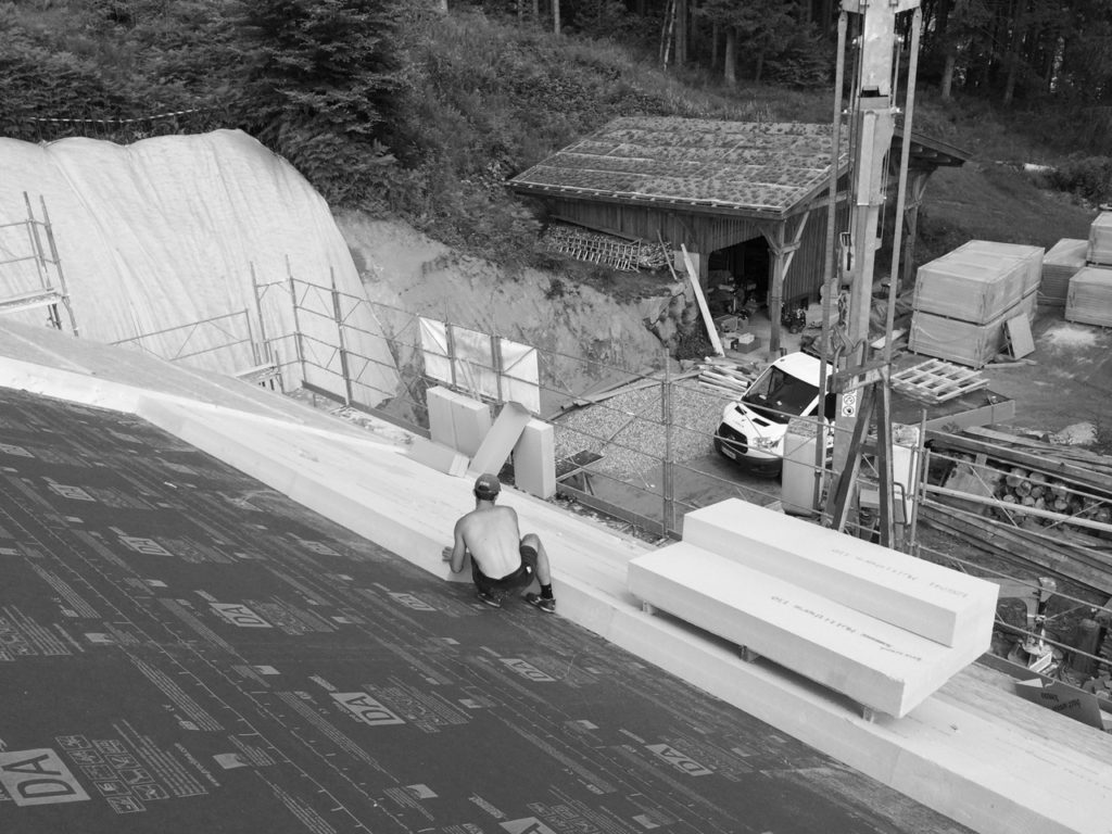 artisan travaillant sur une toiture avec isolation écologique 